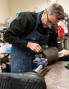 A prosthetist designing and manufacturing an artificial limb