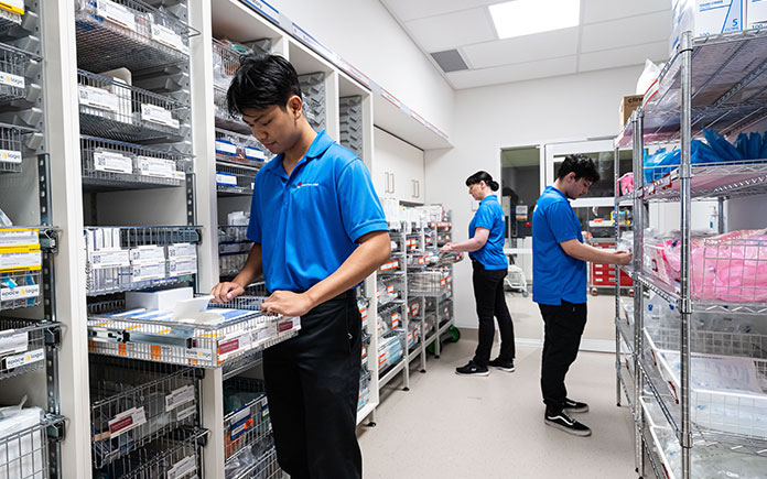 A staff member from the HealthShare NSW Procurement team checking stock supplies in a hospital storeroom.